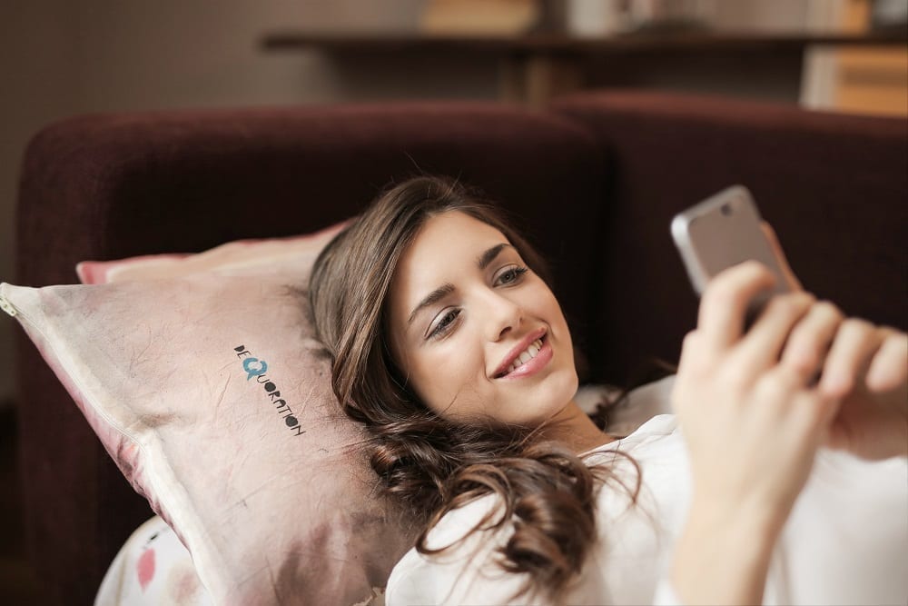 Girl in bed with phone